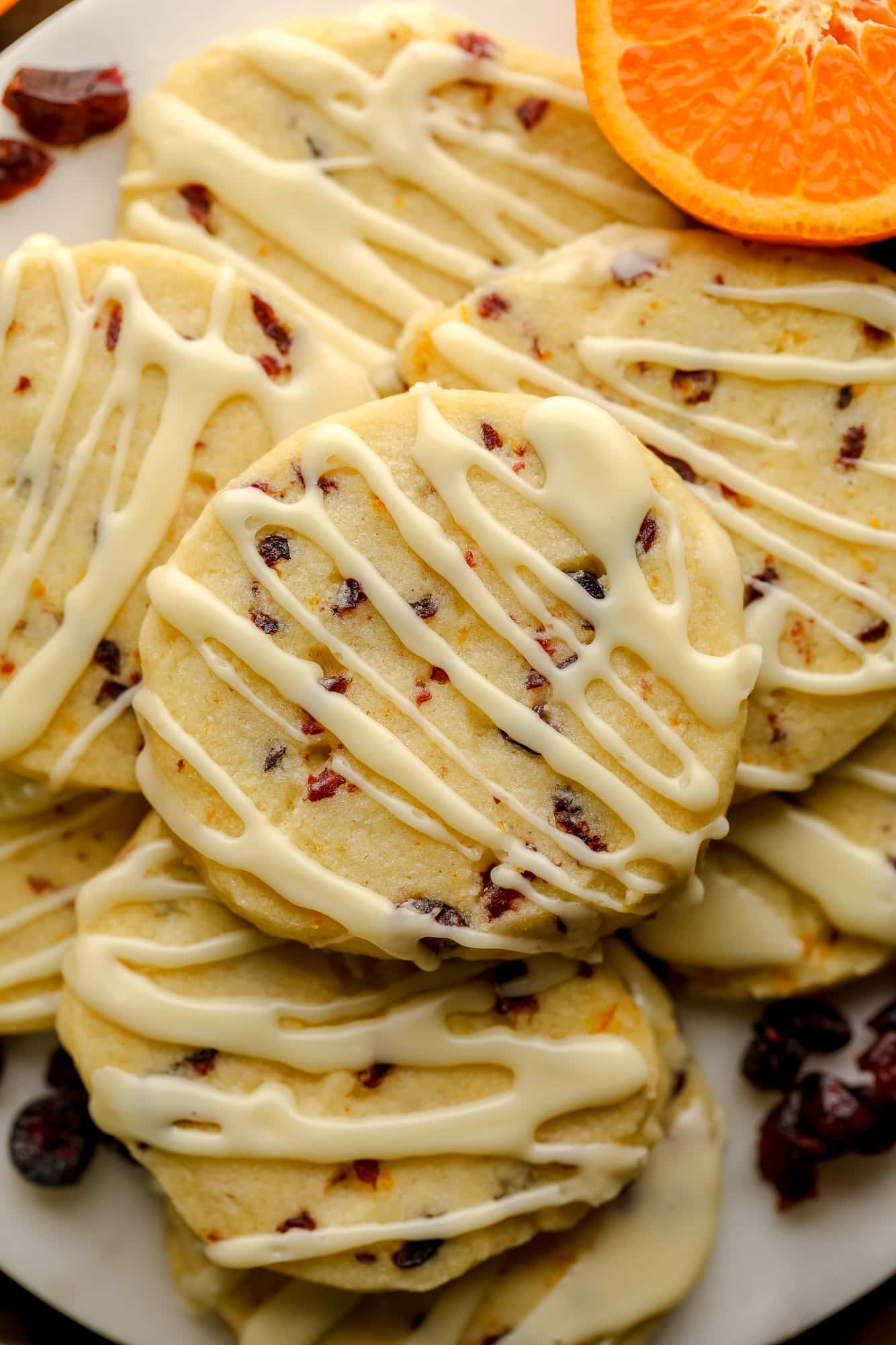 Feche em uma pilha de biscoitos de biscoito de cranberry laranja decorados com esmalte laranja.